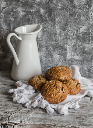 Multi seed whole grain rolls and a enamel jug on a grey wooden rustic backgroundの写真素材