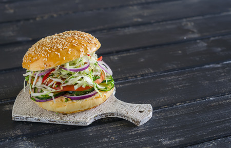delicious veggie burger on a dark wooden surface. Healthy breakfast or snackの写真素材