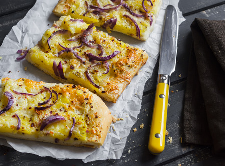 Simple rustic crispy pie with  potatoes, cheese and red onion. Delicious lunch, breakfast or snackの写真素材
