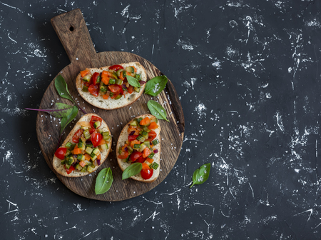 Sandwiches with quick ratatouille on rustic cutting board on a dark background. Delicious healthy vegetarian food. Top viewの写真素材
