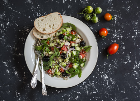 Mediterranean style quinoa and vegetables salad on a dark background. Delicious vegetarian foodの写真素材