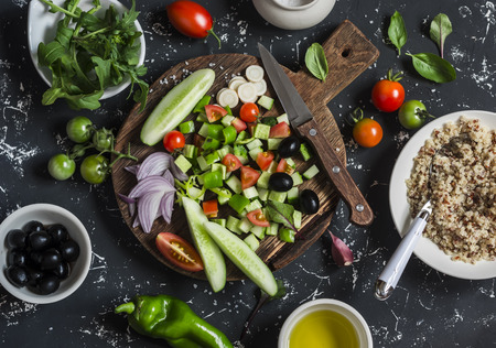 Ingredients for salad - quinoa and vegetables  on a dark background. Delicious vegetarian foodの写真素材