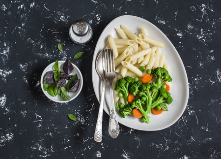 Pasta with broccoli. Delicious healthy vegetarian lunch. On a dark backgroundの写真素材