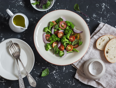 Fresh salad with broccoli and tomatoes on a dark background. Healthy vegetarian foodの写真素材