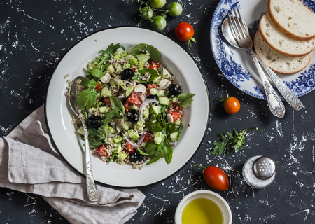 Quinoa and vegetables salad on a dark background. Delicious vegetarian foodの写真素材