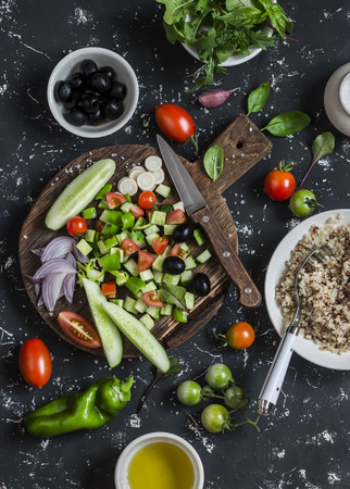 Ingredients for salad - quinoa and vegetables  on a dark background. Delicious vegetarian foodの写真素材