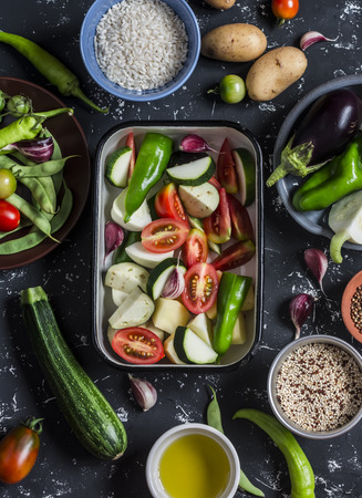 Cooking lunch - fresh raw vegetables, quinoa, rice, spices on a dark background. Vegetarian, diet foodの写真素材