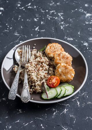 Easy lunch - quinoa and chicken meatballs on a dark background. Healthy delicious foodの写真素材
