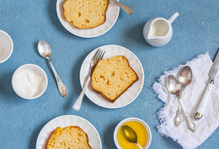 Slices of pumpkin cake on white plates on a blue background.  Delicious autumn dessert.の写真素材