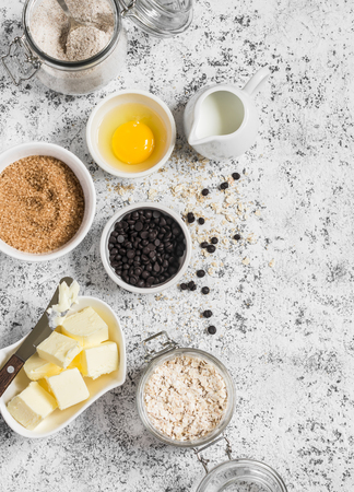 Baking background. Flour, sugar, butter, rolled oats, eggs, chocolate chips on a light background. Baking ingredientsの写真素材