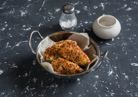 Quinoa crusted chicken in a metal bowl. On a dark background.の写真素材