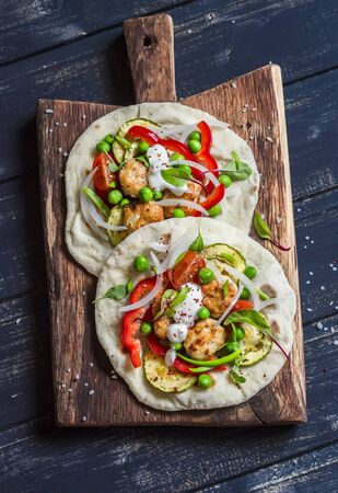 Chicken meatballs and fresh vegetables tacos. Healthy delicious breakfast or snack. On wooden rustic boardの写真素材