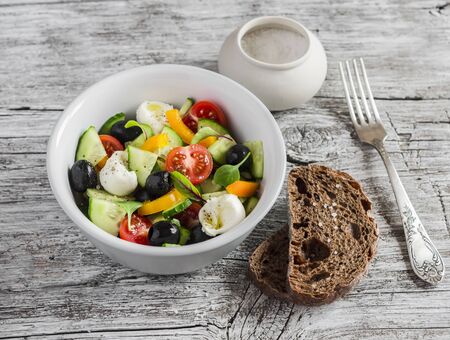 Greek salad on a rustic light wood backgroundの写真素材