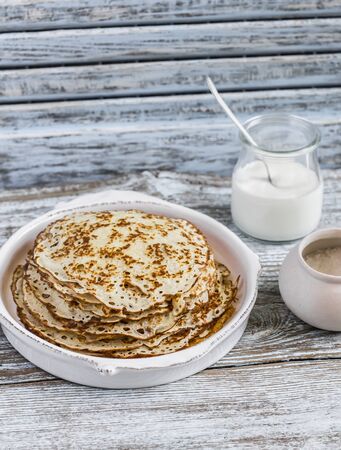 Crepes on a light wooden background. Delicious breakfast or snackの写真素材