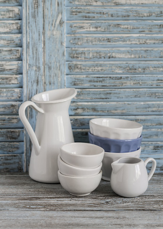 Vintage crockery on a light wooden background. Kitchen still life in rustic styleの写真素材