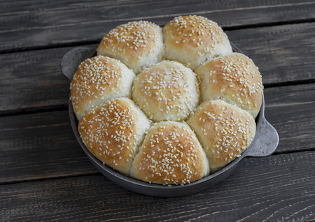 Homemade bread rolls in a vintage pan on wooden backgroundの写真素材
