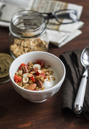 Healthy Breakfast - Greek yogurt and homemade granola on a dark wooden surface. Healthy foodの写真素材
