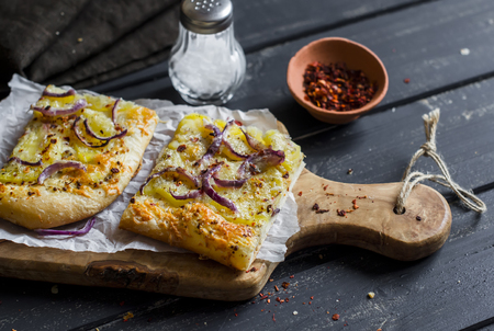Simple rustic crispy pie with  potatoes, cheese and red onion. Delicious lunch, breakfast or snackの写真素材