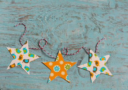 homemade paper Christmas garland on a  wooden surface. Free space for text, rustic styleの写真素材