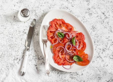 Tomato salad on a light background, top view.の写真素材