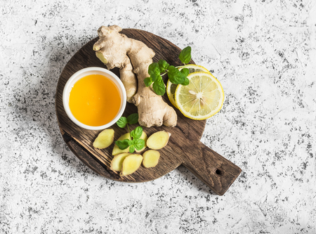 Ingredients for cooking detox drink - ginger, lemon, honey, mint. On a light background, top viewの写真素材