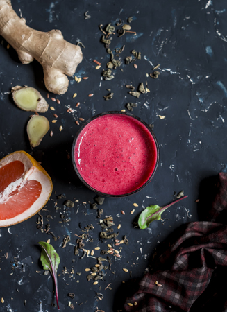 Beet and Ginger Detox Elixir. On a dark background, top viewの写真素材