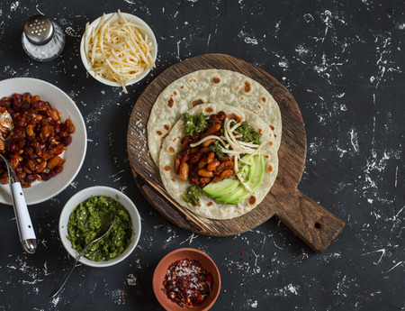 Tortilla with beans, avocado, cheese and spicy chili sauce. Mexican food.の写真素材