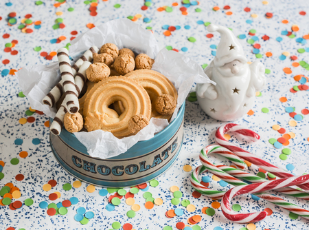 Christmas cookies gift box. Cookies, candies and christmas ornament Santa Claus on a light backgroundの写真素材
