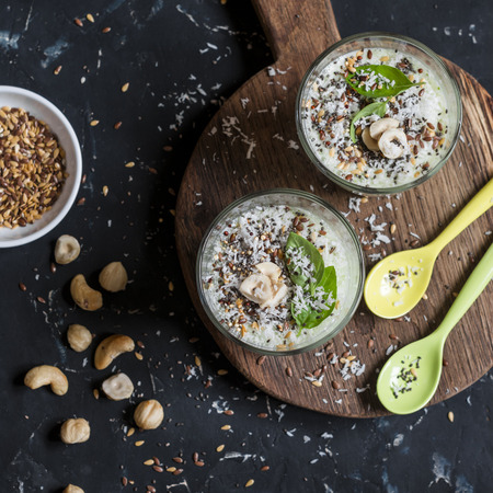 Two detox smoothie cup on a wooden board on a dark background. Healthy foodの写真素材