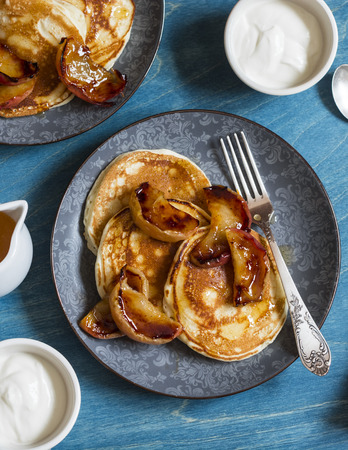 Buttermilk pancake with roasted honey cinnamon apples. Delicious Breakfast on a wooden table, top viewの写真素材