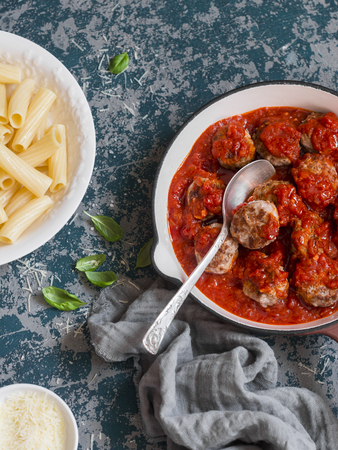 Turkey meatballs in tomato sauce and rigatoni pasta. Delicious lunch, top viewの写真素材