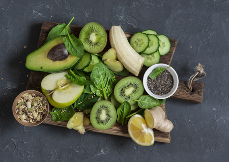Detox green vegetables and fruits on a wooden board. Concept of a healthy, diet food. Smoothie ingredients.Top viewの写真素材