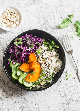 Wild rice, roasted pumpkin, red cabbage buddha bowl. Vegetarian food concept. On a light background, top viewの写真素材