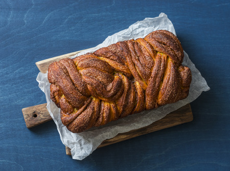 Pumpkin cinnamon brioche on a blue background, top view