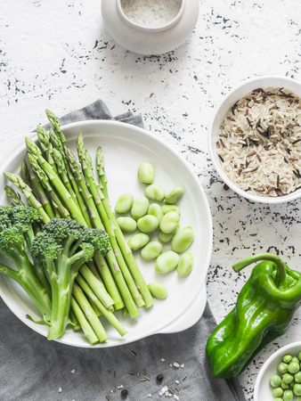 Ingredients for lunch - wild rice, asparagus, broccoli, green beans on a light background, top view. Vegetarian food conceptの写真素材