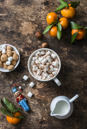 Cozy wooden background with hot chocolate, fresh tangerines, biscuits. Top view, flat layの写真素材