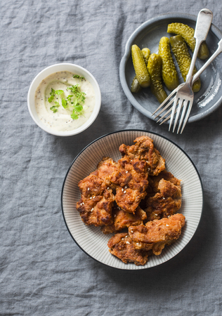 Deep fried chicken, pickles and mayonnaise, mustard sauce on a gray background, top view. Appetizer, snack tableの写真素材