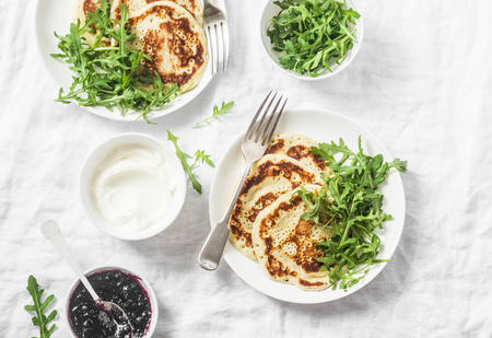 Gluten free chickpea pancake and arugula. Healthy diet breakfast or snack on white background, top viewの写真素材