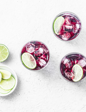 Cold hibiscus tea with ice on white background, top view. Refreshing summer cocktailの写真素材