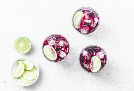 Cold hibiscus tea with ice on white background, top view. Refreshing summer cocktailの写真素材