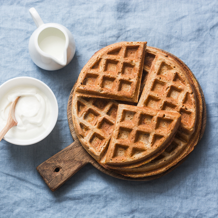 Savory gluten free breakfast waffles on a blue background, top view. Vegetarian food conceptの写真素材