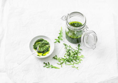 Arugula pesto on a light background, top view. Tasty seasoning for pasta, bruschettaの写真素材