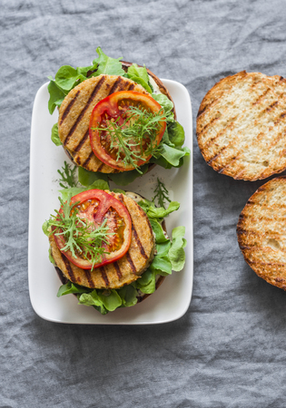 Turmeric, sweet potatoes, chickpeas vegetarian burger. Healthy vegetarian food concept. On a gray background, top viewの写真素材