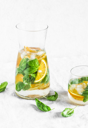 Orange basil  detox lemonade on a light background. Vegetarian, diet, weight loss, summer drink conceptの写真素材