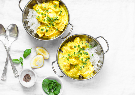 Chicken coconut milk curry sauce with rice on a light background, top view. Indian style foodの写真素材