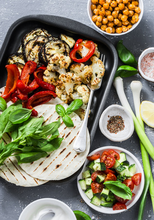 Ingredients for cooking summer grilled garden vegetables and spicy chickpeas vegetarian tortillas on grey background, top view. Healthy food picnic conceptの写真素材