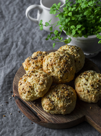 Homemade cheddar and seeds buns - delicious breakfast, brunch, snack on grey backgroundの写真素材