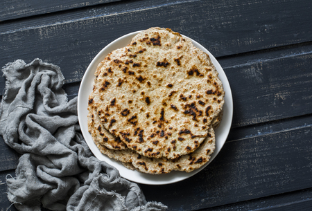 Gluten free healthy diet flatbreads on dark background, top viewの写真素材