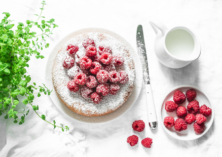Simple butter cake with raspberry on light background, top view. Delicious summer dessert. Flat layの写真素材