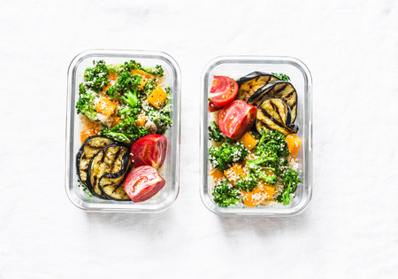 Vegetarian lunch box. Broccoli, pumpkin, couscous salad, grilled eggplant and tomatoes. Healthy diet home food concept. Office food. On light background, copy spaceの写真素材